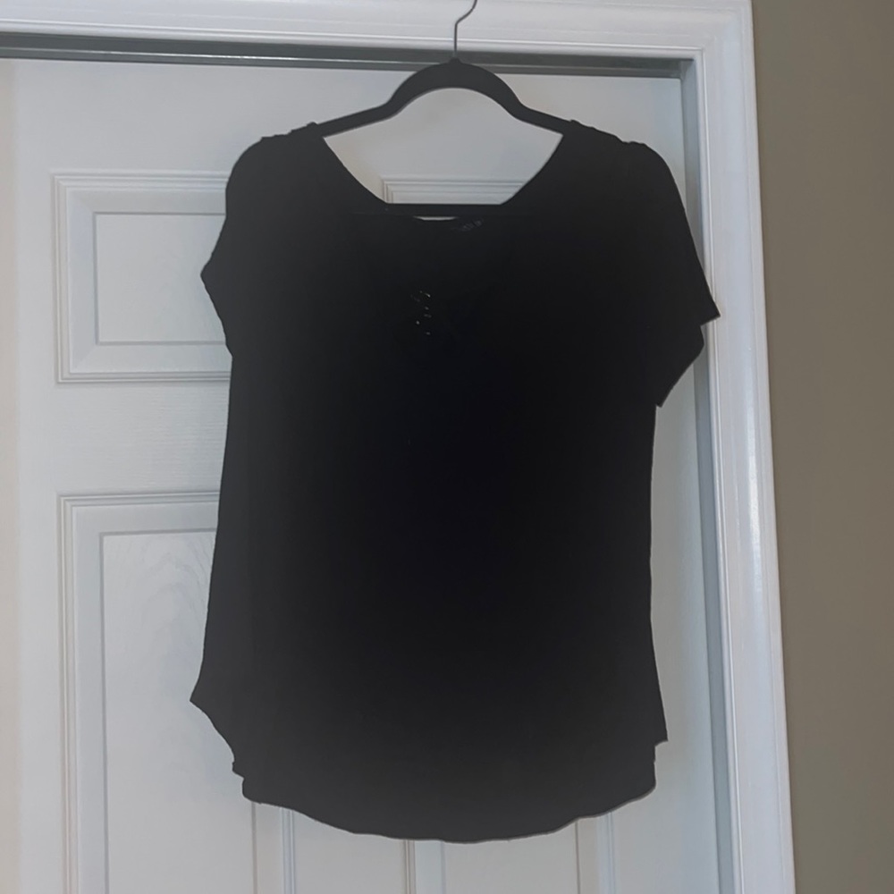Black crisscross neckline top with gold accents in the crisscross